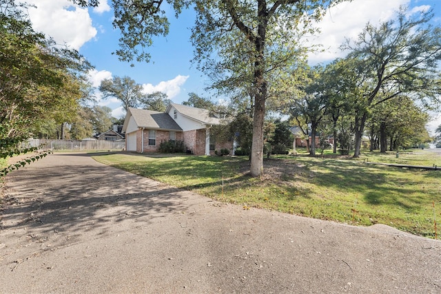 105 Lost Oaks Dr, Waco, TX 76705 - view of side of home featuring brick siding and driveway