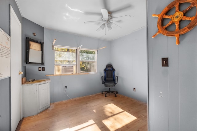 interior space featuring light wood-type flooring, ceiling fan, and cooling unit