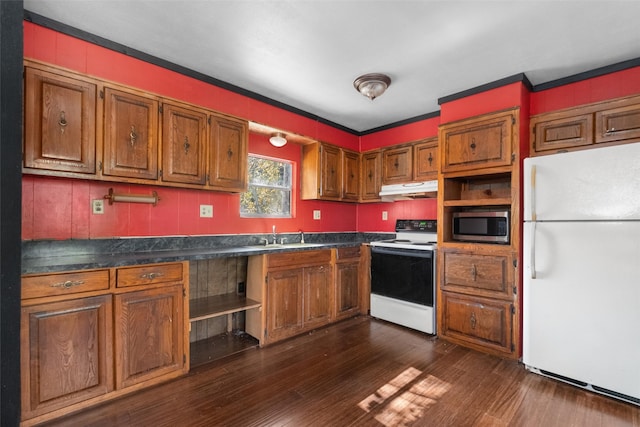 kitchen featuring ornamental molding, white appliances, dark wood-type flooring, and sink