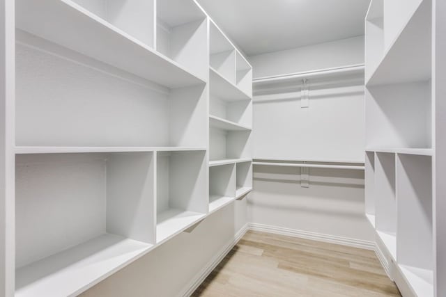 walk in closet featuring light hardwood / wood-style flooring