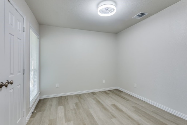 empty room with light hardwood / wood-style flooring