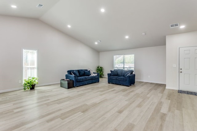 living room with light hardwood / wood-style flooring and vaulted ceiling