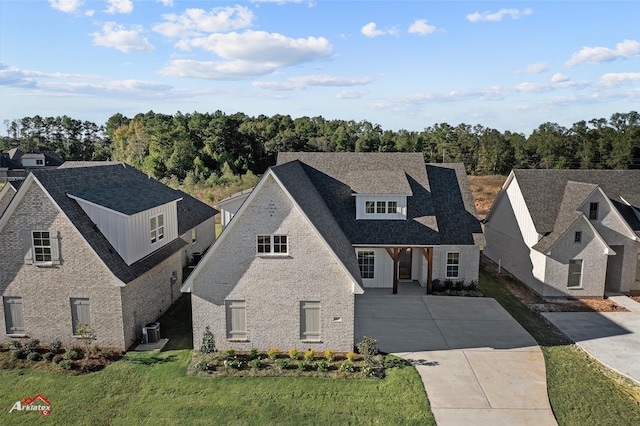 view of front of house with central air condition unit and a front yard