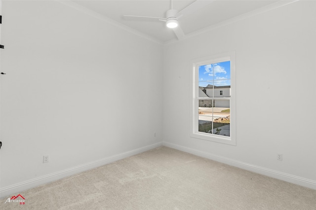 spare room featuring ceiling fan, crown molding, and light carpet