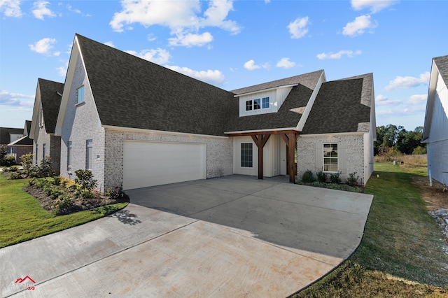 view of front of home featuring a garage and a front lawn