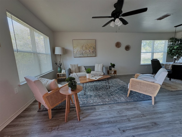 living room with hardwood / wood-style flooring, plenty of natural light, and ceiling fan