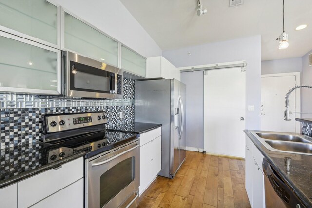 kitchen featuring white cabinetry, appliances with stainless steel finishes, and light hardwood / wood-style floors