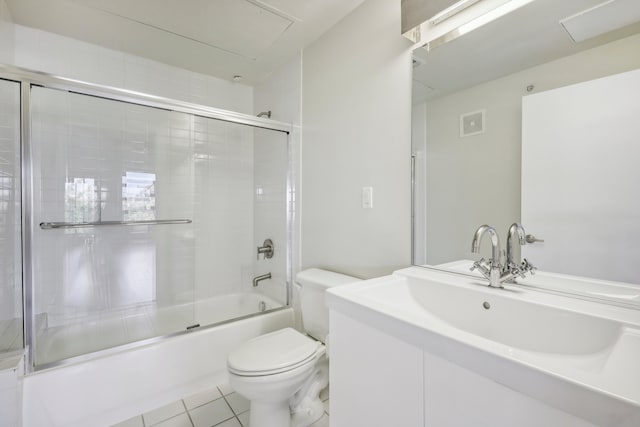 full bathroom featuring shower / bath combination with glass door, tile patterned floors, vanity, and toilet