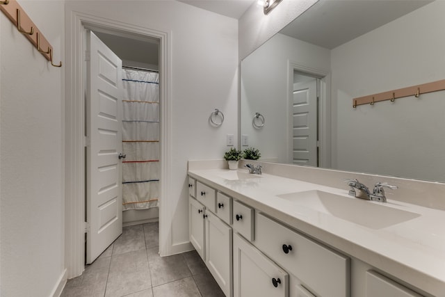 bathroom with tile patterned flooring and vanity