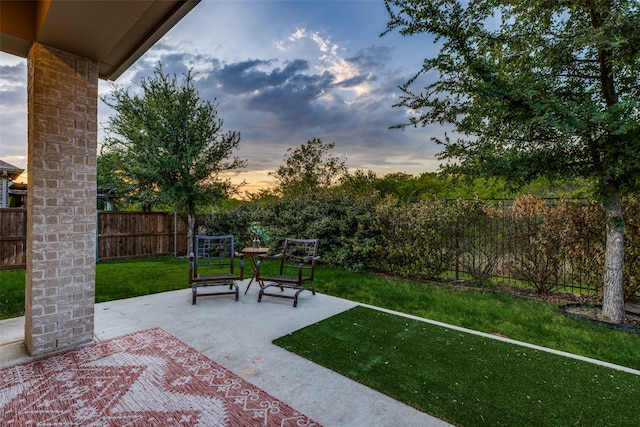 patio terrace at dusk with a yard