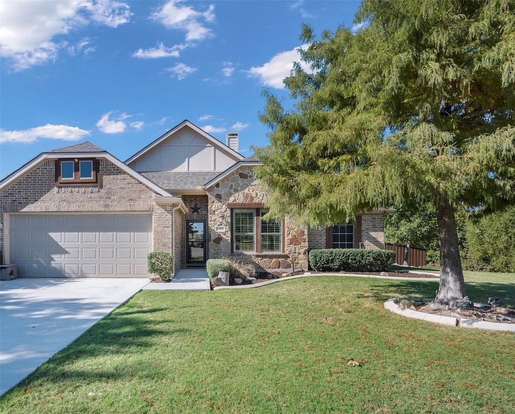 view of front of home with a front yard and a garage