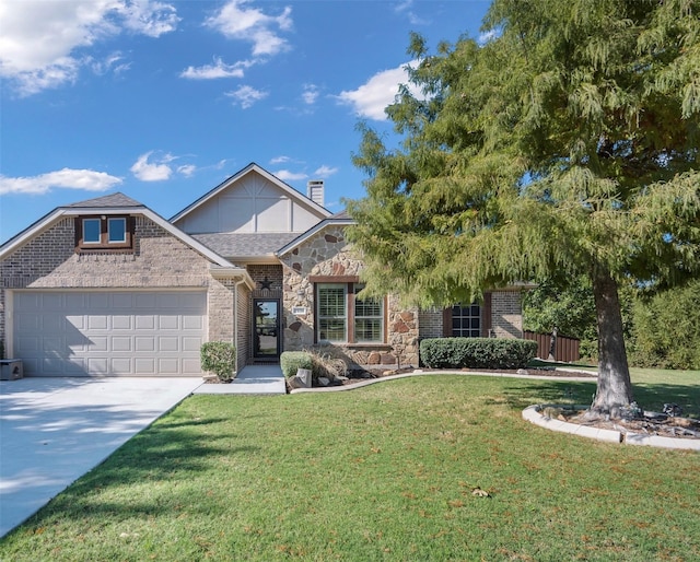 view of front of home with a front yard and a garage