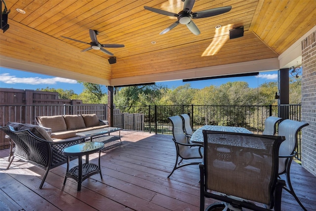 wooden terrace with ceiling fan and an outdoor hangout area