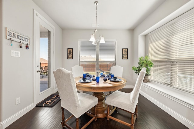 dining room featuring dark hardwood / wood-style floors and a notable chandelier