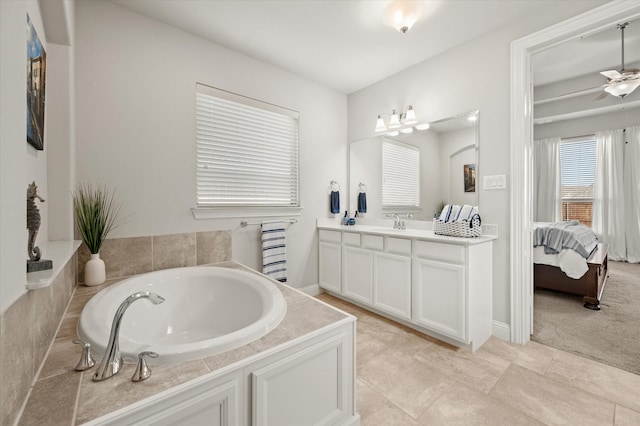 bathroom with a bath, vanity, tile patterned floors, and ceiling fan