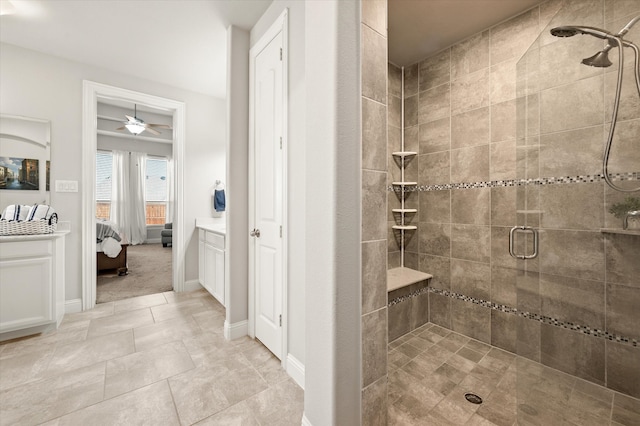 bathroom with tile patterned flooring, ceiling fan, and a shower with shower door