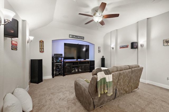 carpeted home theater room featuring vaulted ceiling and ceiling fan