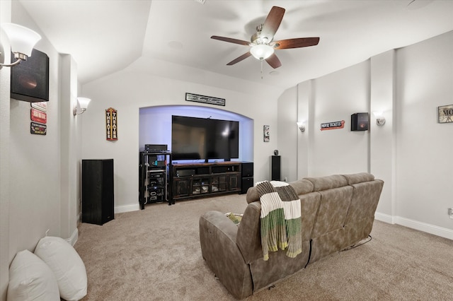 home theater room with ceiling fan, light carpet, and vaulted ceiling