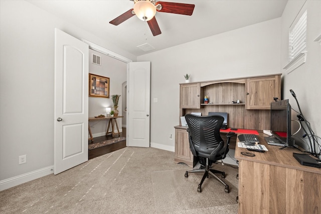 carpeted home office featuring ceiling fan