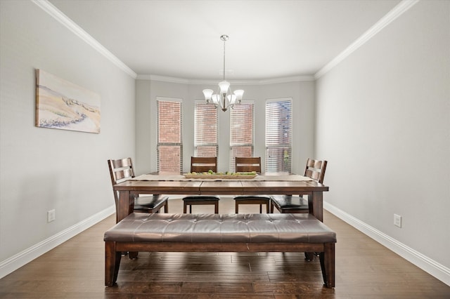 dining area with hardwood / wood-style floors, a notable chandelier, and crown molding