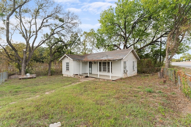 rear view of property with a lawn