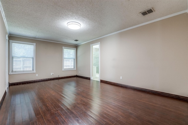 empty room with a textured ceiling, dark hardwood / wood-style floors, and ornamental molding