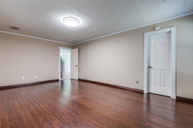 spare room with dark hardwood / wood-style flooring, a textured ceiling, and ornamental molding