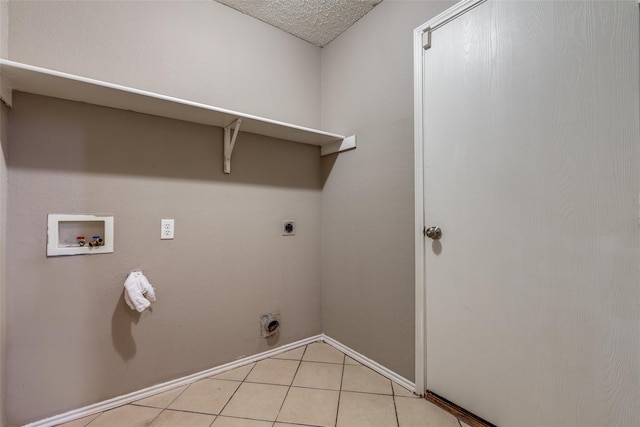 laundry area with electric dryer hookup, light tile patterned floors, washer hookup, and a textured ceiling