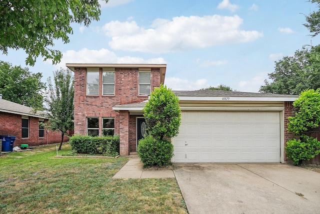 view of property featuring a garage and a front lawn