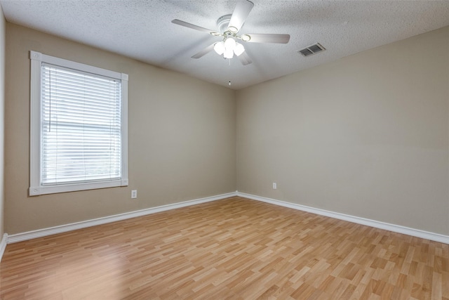 unfurnished room featuring ceiling fan, light hardwood / wood-style floors, and a textured ceiling