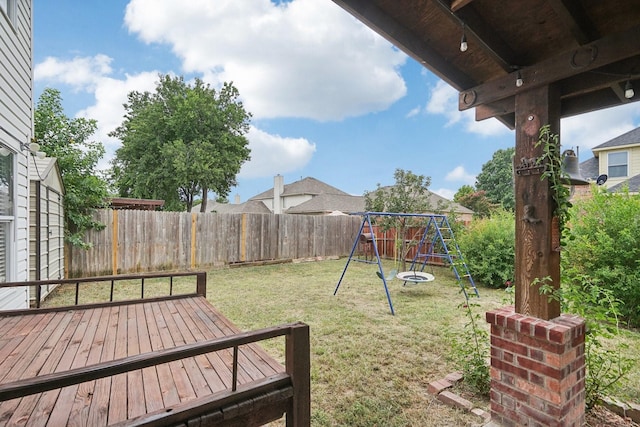 view of yard with a playground and a wooden deck