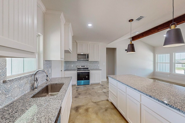 kitchen with beamed ceiling, stainless steel appliances, a healthy amount of sunlight, and sink