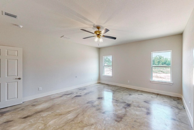 empty room featuring a textured ceiling and ceiling fan