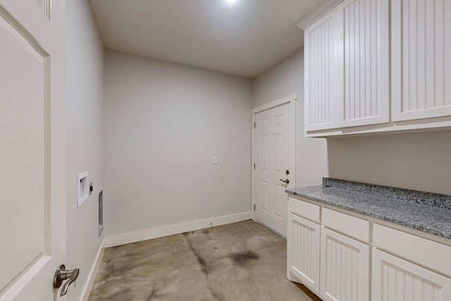 clothes washing area with cabinets and washer hookup