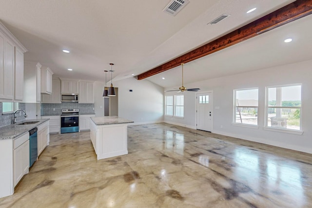 kitchen with white cabinetry, sink, stainless steel appliances, vaulted ceiling with beams, and a kitchen island