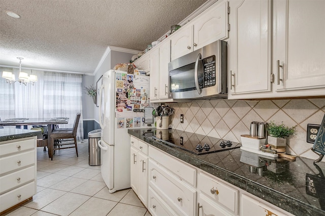 kitchen with a chandelier, black electric stovetop, white cabinetry, and crown molding