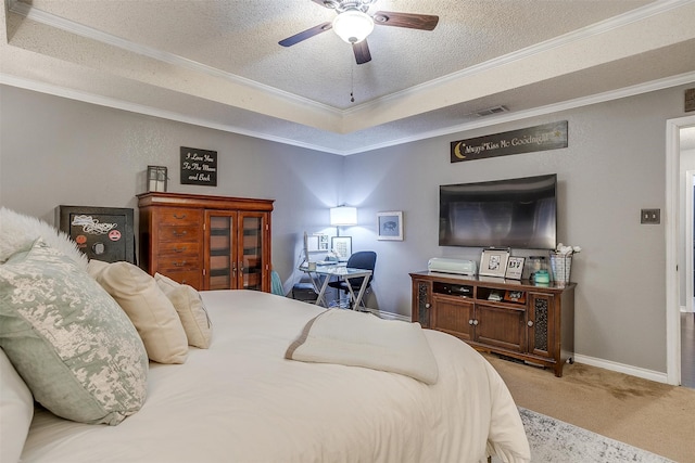 bedroom with carpet, ornamental molding, a textured ceiling, a raised ceiling, and ceiling fan