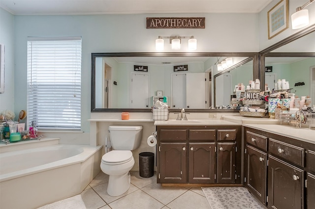 bathroom featuring tile patterned floors, vanity, toilet, and a bathtub