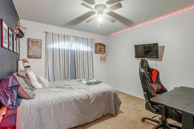 bedroom featuring ceiling fan, light colored carpet, and a textured ceiling