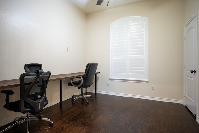 home office with dark hardwood / wood-style flooring and ceiling fan