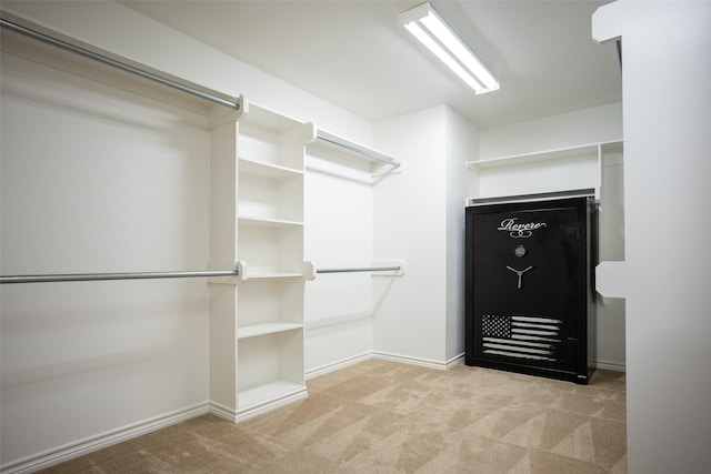 walk in closet featuring light carpet