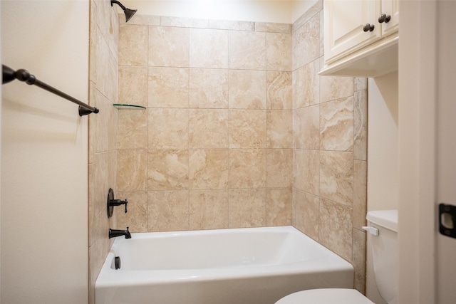 bathroom featuring tiled shower / bath combo and toilet