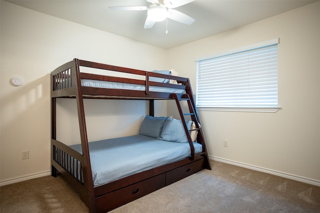 unfurnished bedroom with dark carpet and ceiling fan