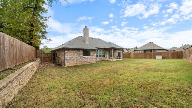 rear view of property featuring a yard