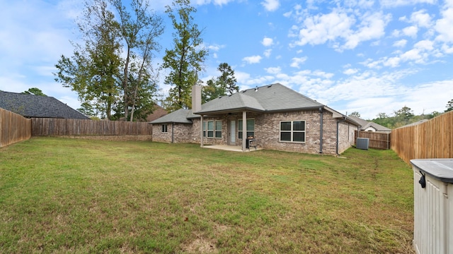 back of house featuring a patio, a yard, and central air condition unit