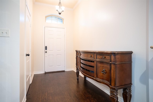 foyer featuring ornamental molding, dark hardwood / wood-style floors, and a chandelier