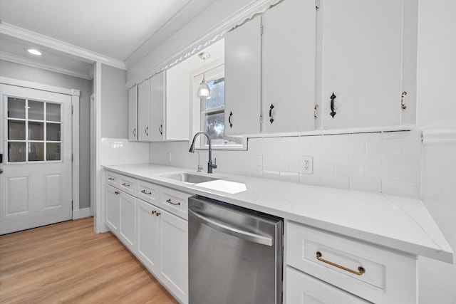 kitchen featuring sink, crown molding, dishwasher, white cabinets, and decorative light fixtures