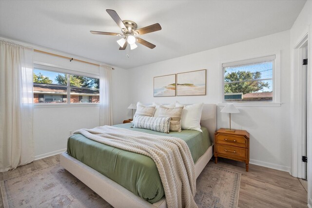 bedroom featuring ceiling fan, a closet, and a crib