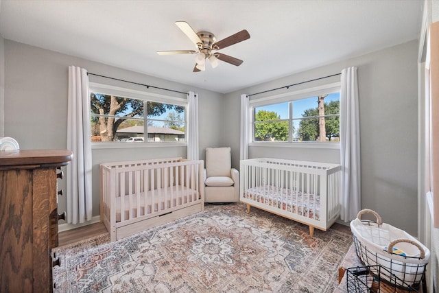 300 L S P Cir, Kerens, TX 75144 - bedroom featuring wood finished floors, a crib, and a ceiling fan