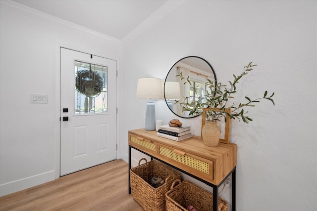 entrance foyer with ornamental molding and light wood-type flooring